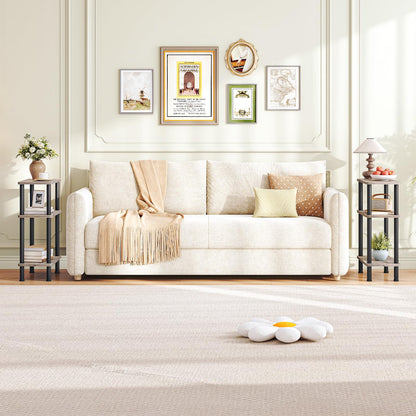 Living room with a white sofa, decorative pillows, and framed pictures on the wall.