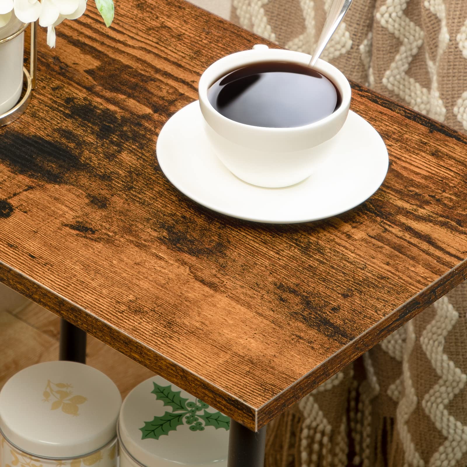 White cup of coffee on a wooden table with a patterned fabric background