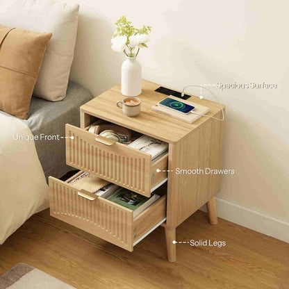 Angled top view of the nightstand with both drawers open, displaying large interior storage capacity next to a bed.