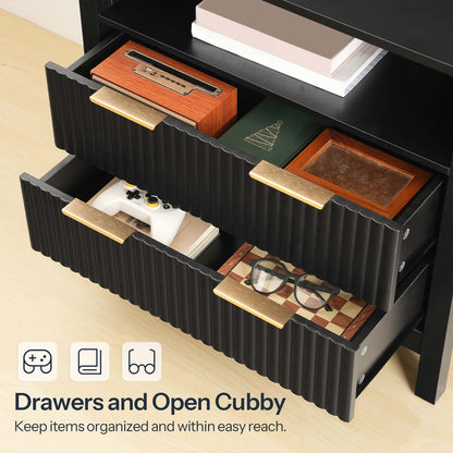 Black storage unit with open drawers and a cubby, containing items like books and a game console.