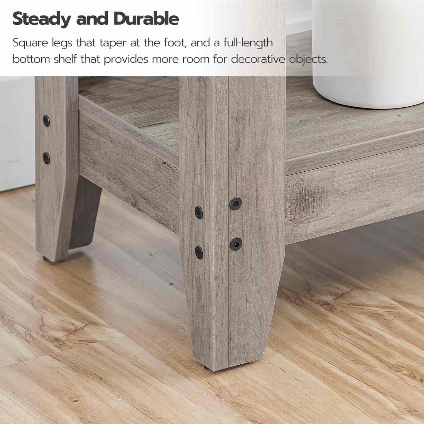 Wooden table with square legs and a full-length bottom shelf on a wooden floor.