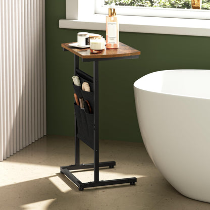 Bathroom scene with a wooden side table against a green wall, next to a white freestanding bathtub.