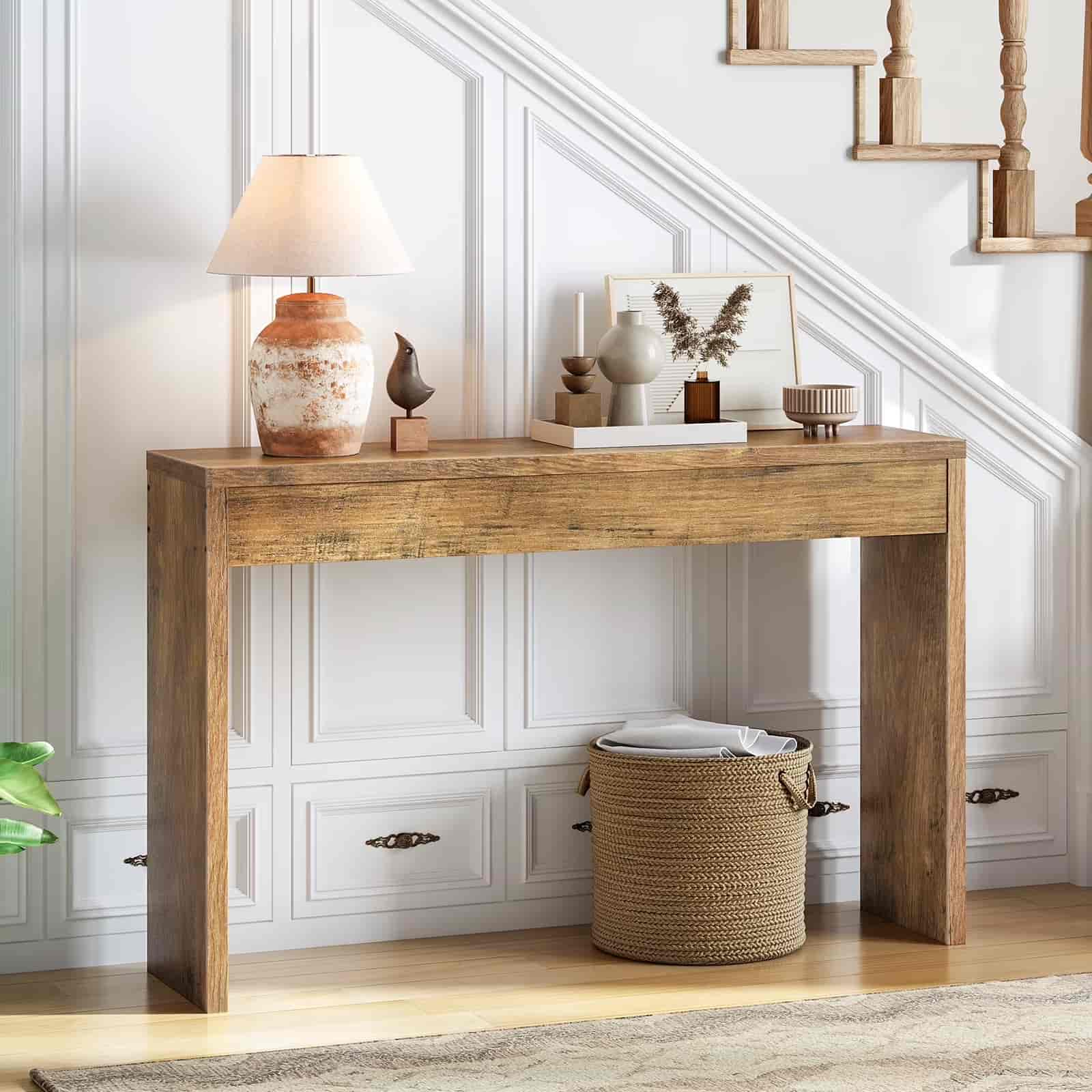 Wooden console table with decorative items against a white wall.