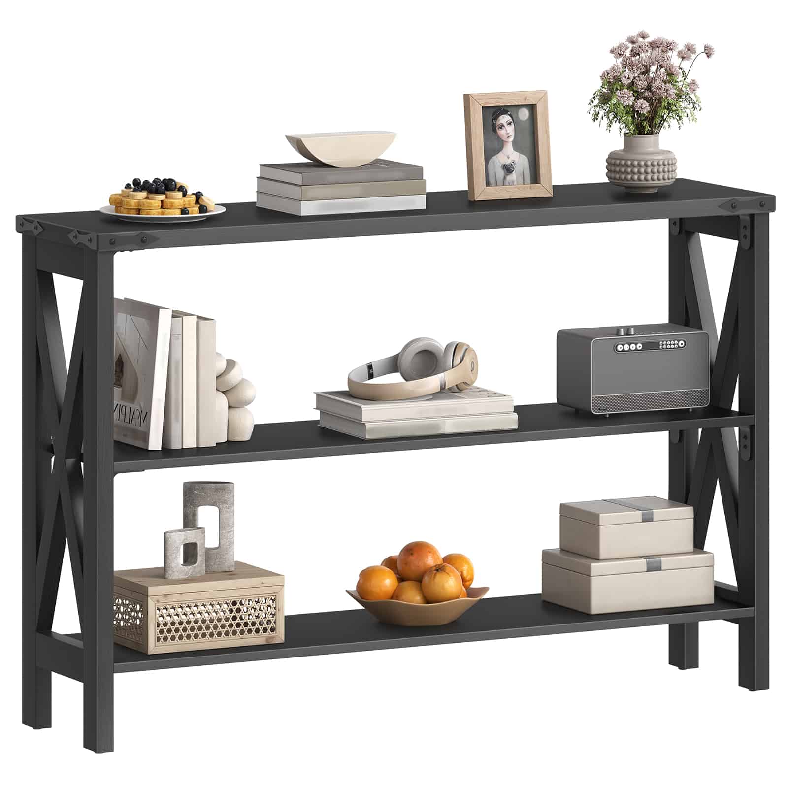 Three-quarter front view of a 3-tier slim black sofa table styled with picture frames, flower vases, and storage boxes.