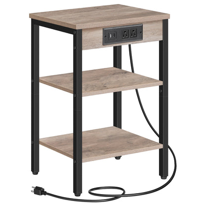 Isolated front view of a 3-tier slim end table with an attached black power cord and greige shelves.