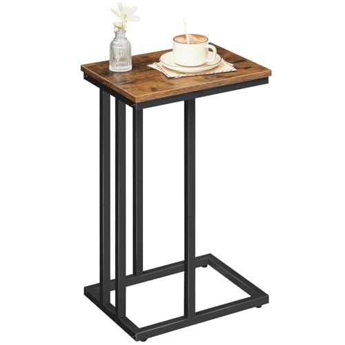Small wooden side table with a black metal frame, featuring a cup and decorative items on top.