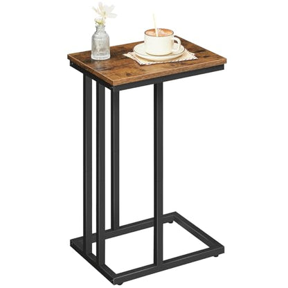 Small wooden side table with a black metal frame, featuring a cup and decorative items on top.