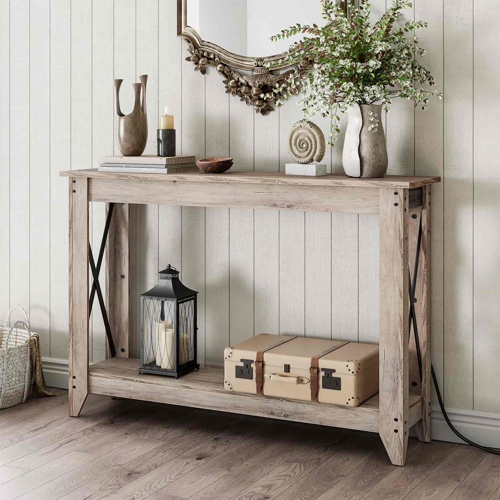 Wooden console table with decorative items against a white paneled wall.