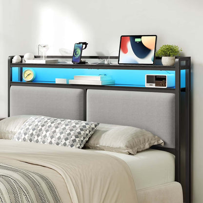 Bedroom setup with a bed, desk, and electronic devices on a white wall background