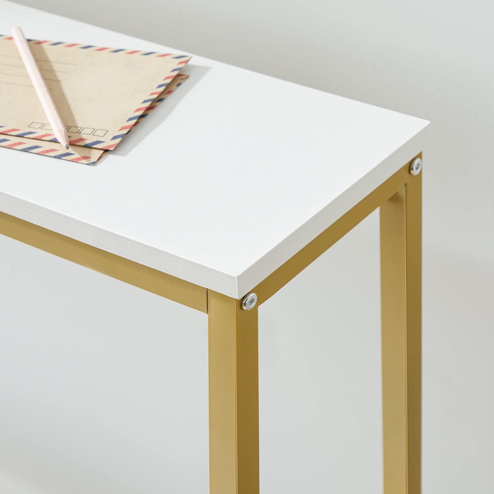 Small white table with gold legs on a plain background
