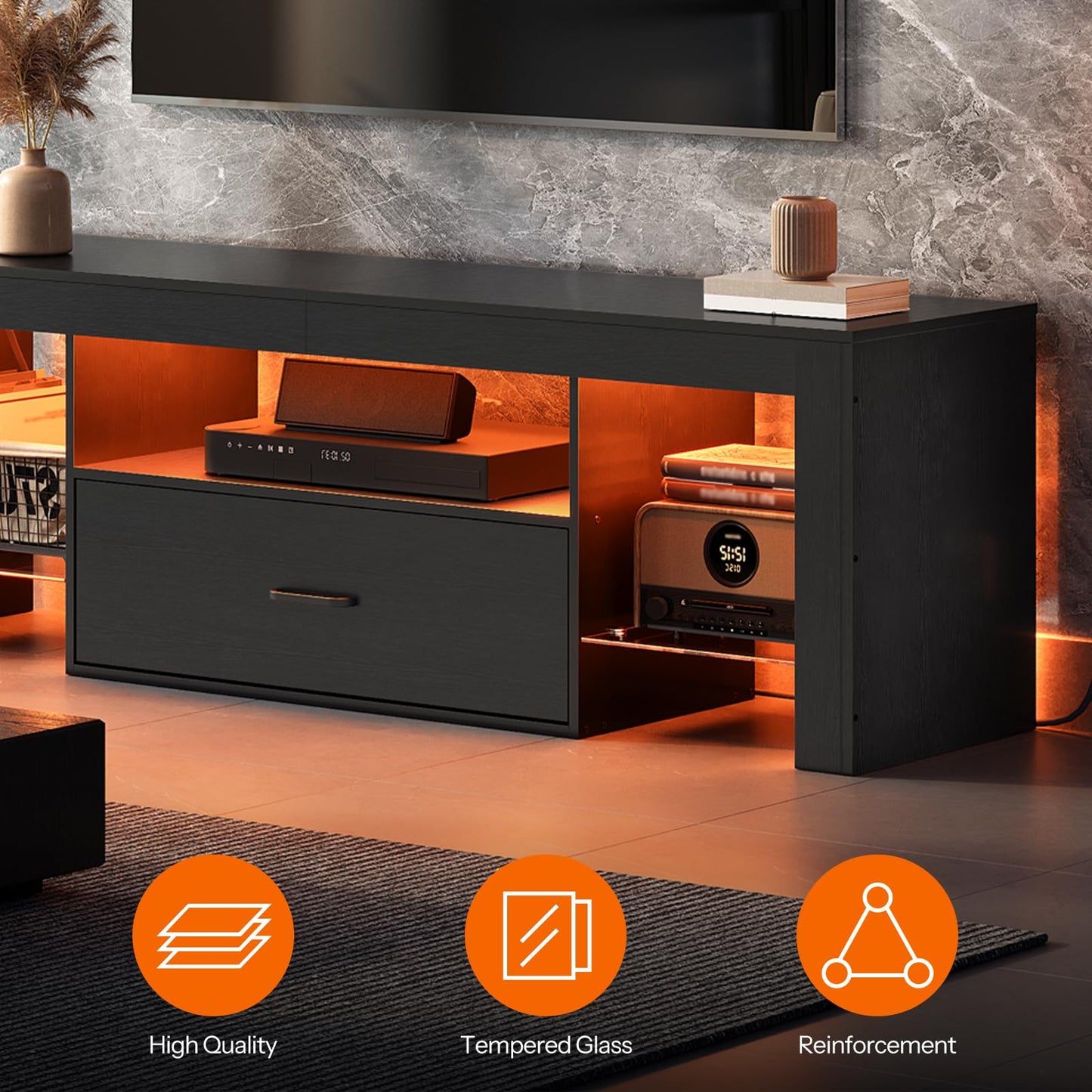 Black entertainment console with open doors revealing electronic devices in a room setting.