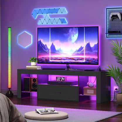Modern living room with a TV on a black entertainment console, colorful wall lights, and decorative plants.