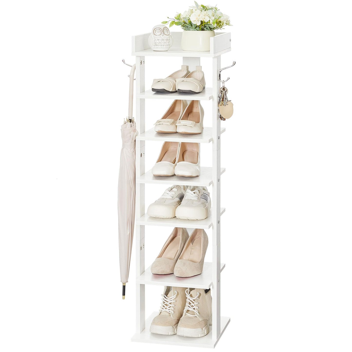 White shoe rack with shoes, an umbrella, and a plant on a white background