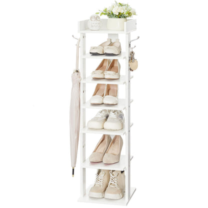 White shoe rack with shoes, an umbrella, and a plant on a white background