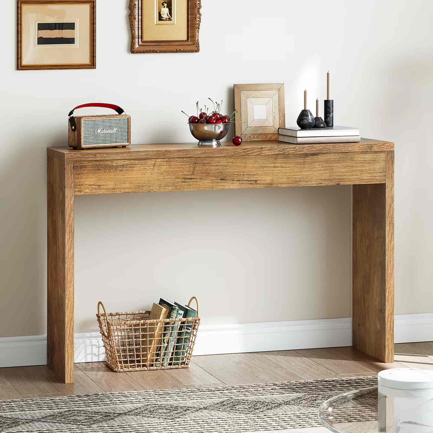 Wooden console table with decorative items against a white wall