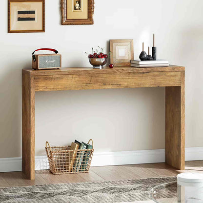 Wooden console table with decorative items against a white wall