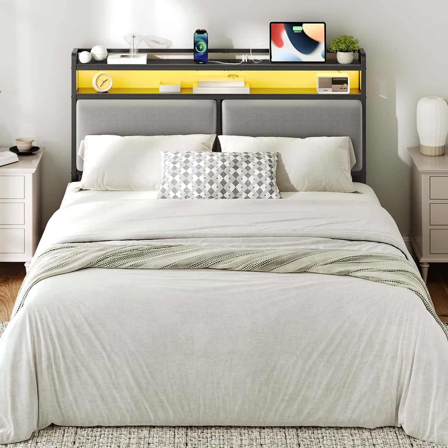Bedroom with a neatly made bed, nightstands, and a headboard with electronic devices.