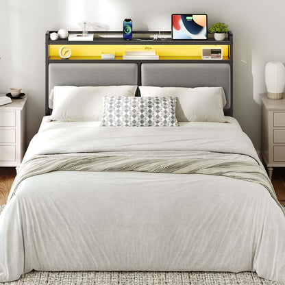 Bedroom with a neatly made bed, nightstands, and a headboard with electronic devices.