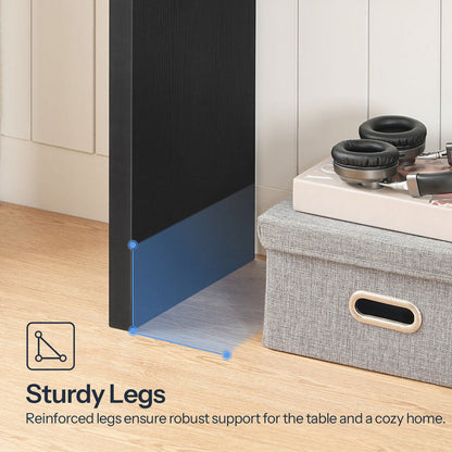 Gray storage box with a black TV stand and headphones on a wooden floor.