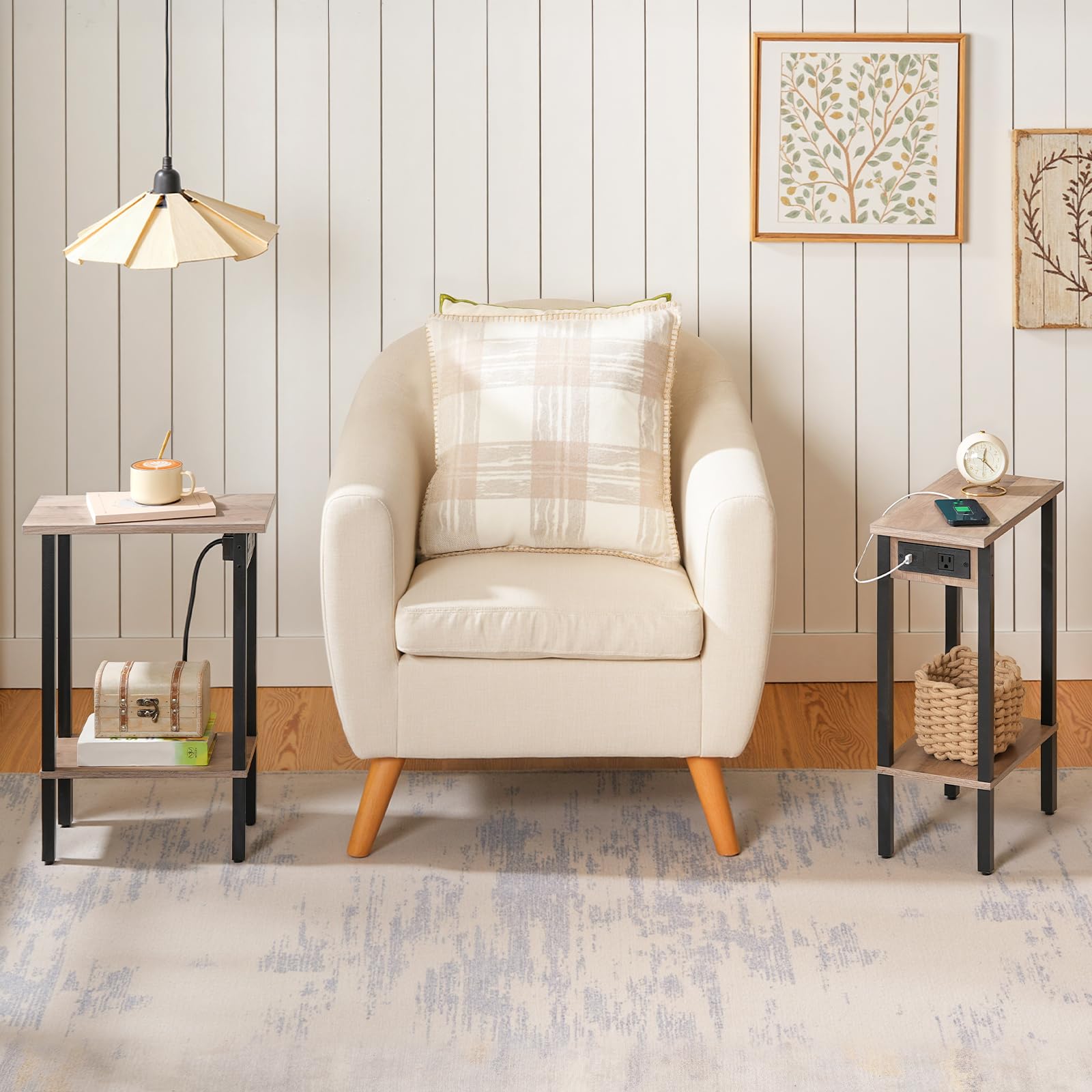 Beige armchair with plaid pillow in a room with side tables and wall art.