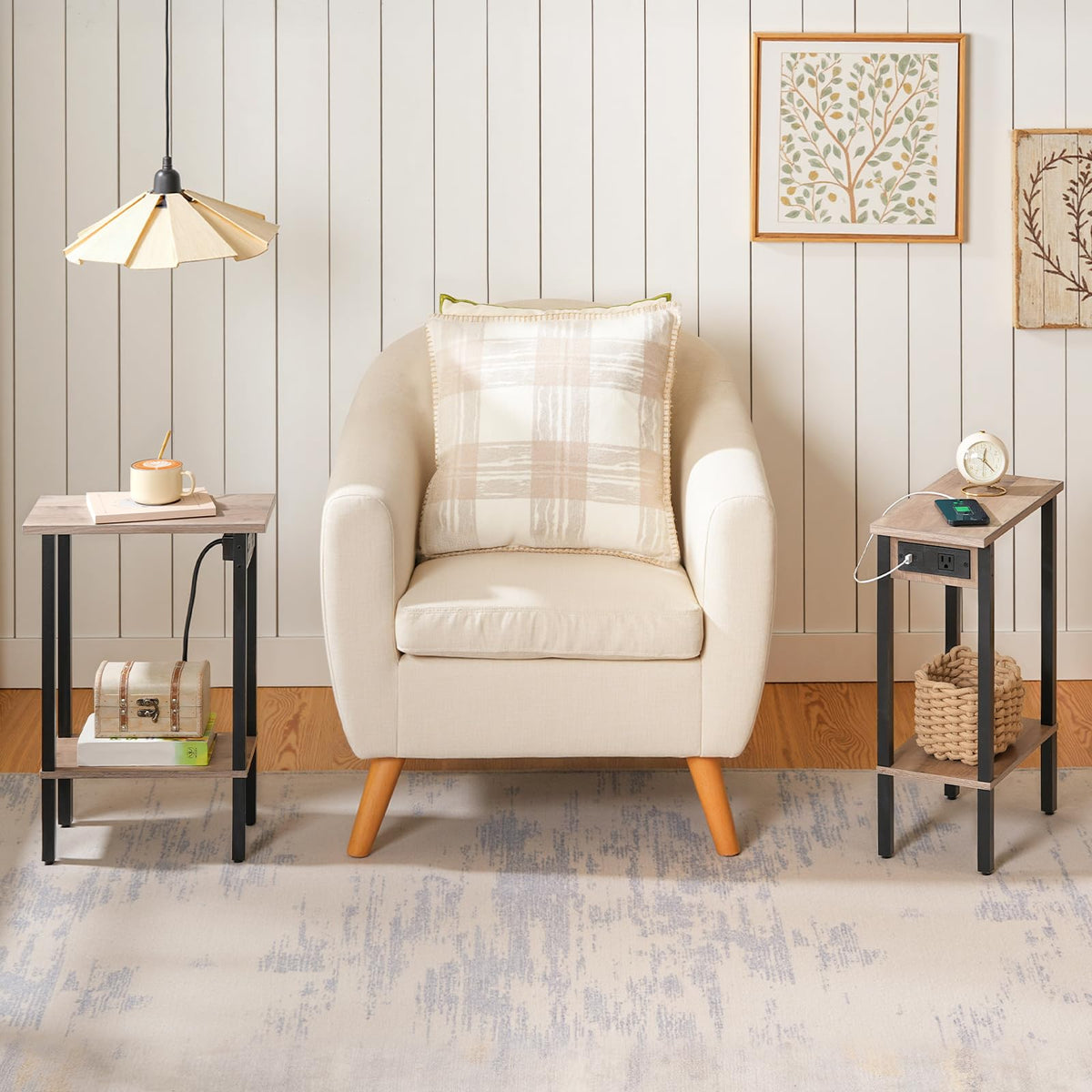 Beige armchair with plaid pillow in a room with side tables and wall art.