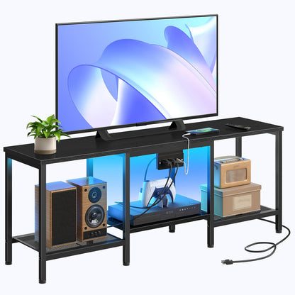 Black TV stand with a television, speakers, and decorative items on a white background