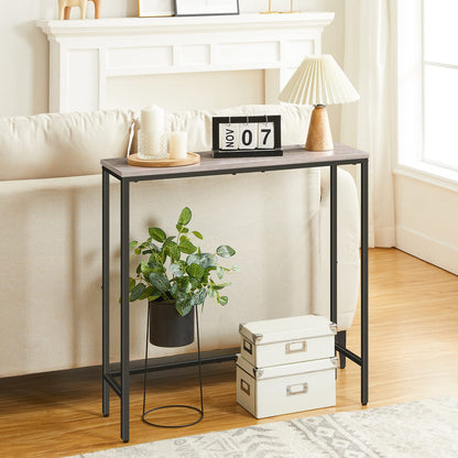 Small black metal console table with decorative items in a living room setting.