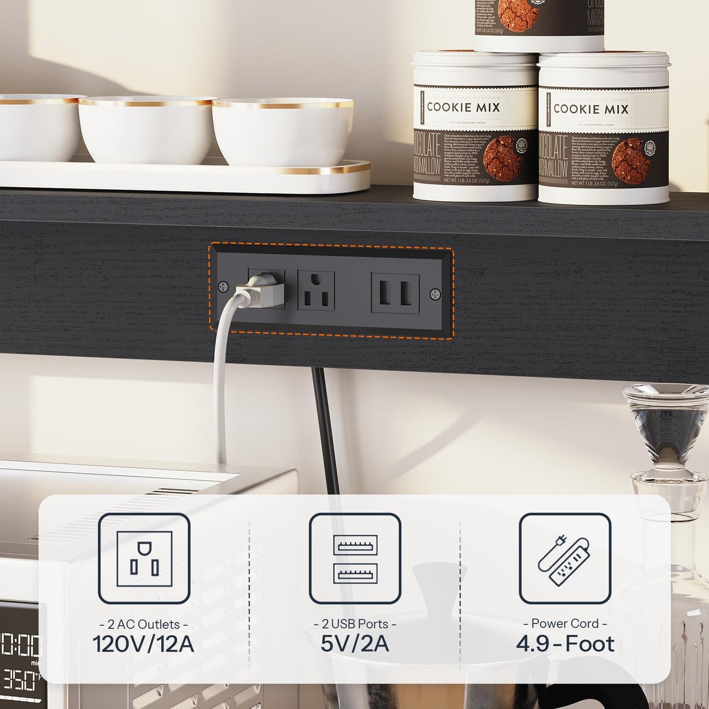 Power strip with multiple outlets and USB ports on a kitchen counter with cookie mix containers in the background.