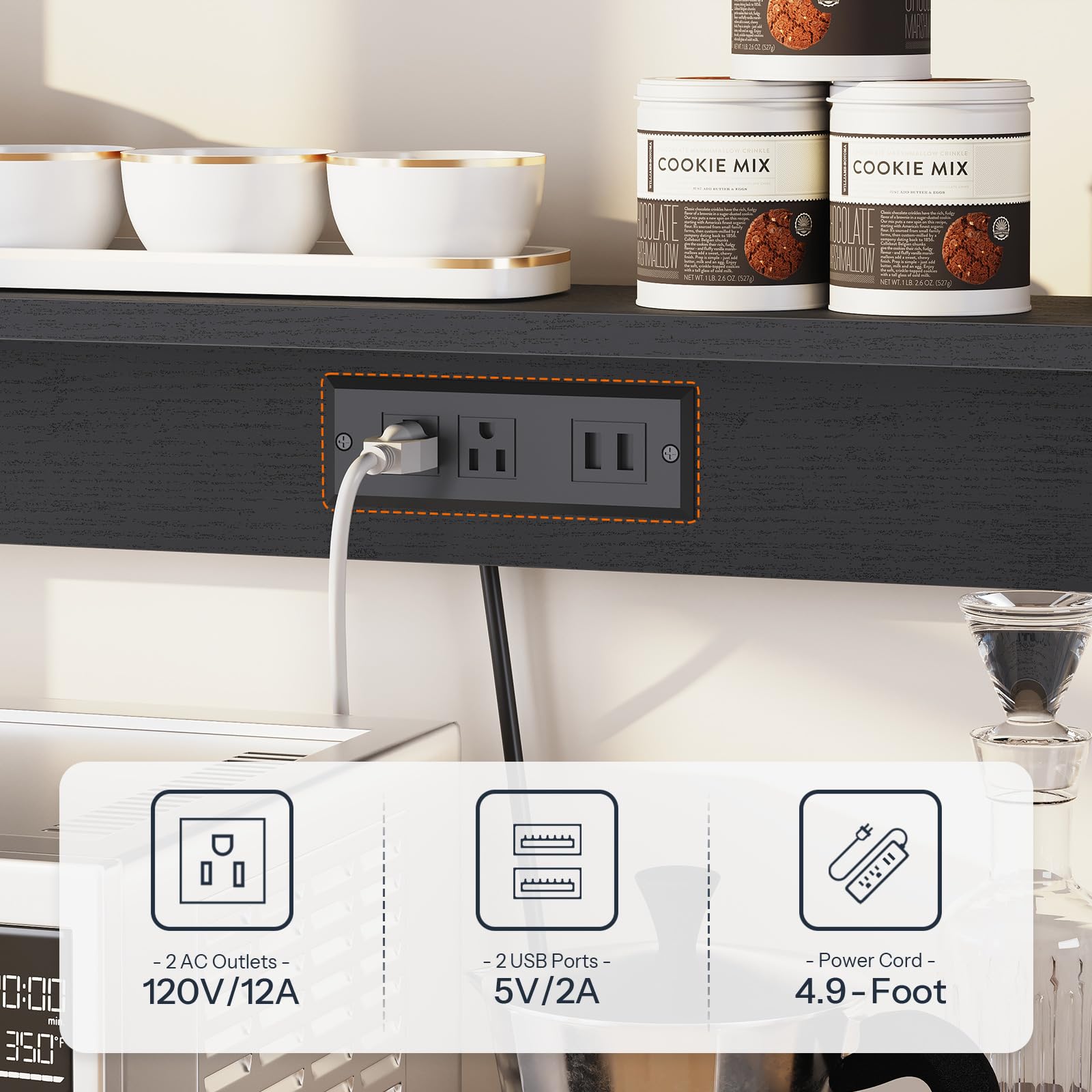 Power strip with multiple outlets and USB ports on a kitchen counter with cookie mix containers in the background.