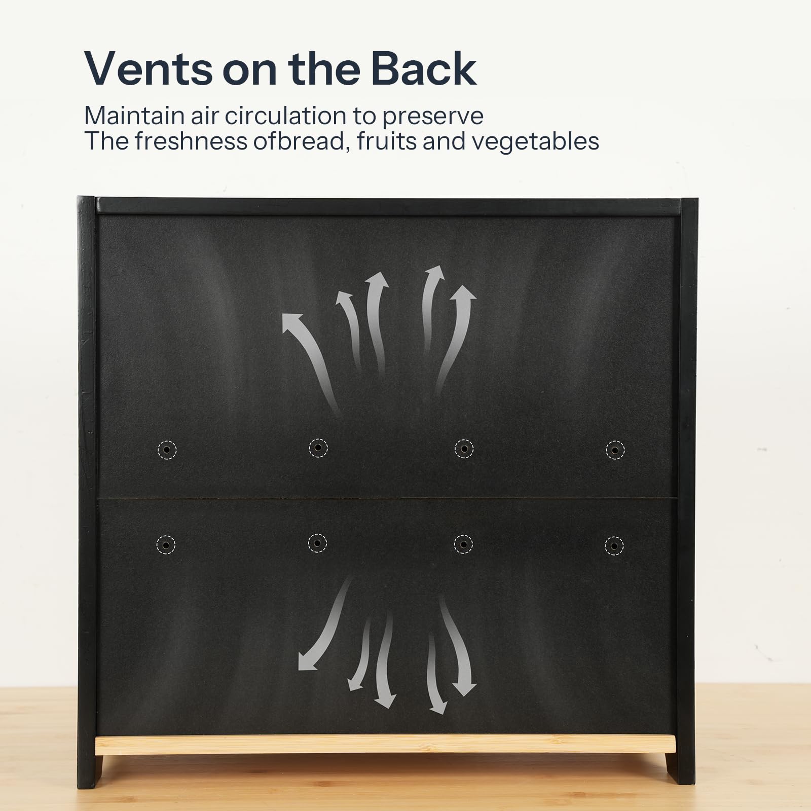 Black vegetable drawer with vent design on a wooden surface