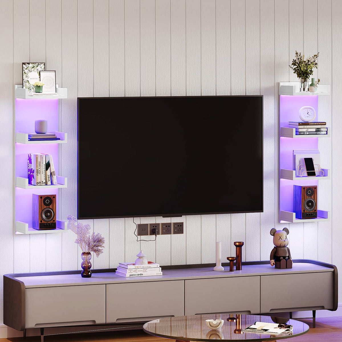 Modern living room setup with a TV mounted on a wall, flanked by shelves with decorative items.