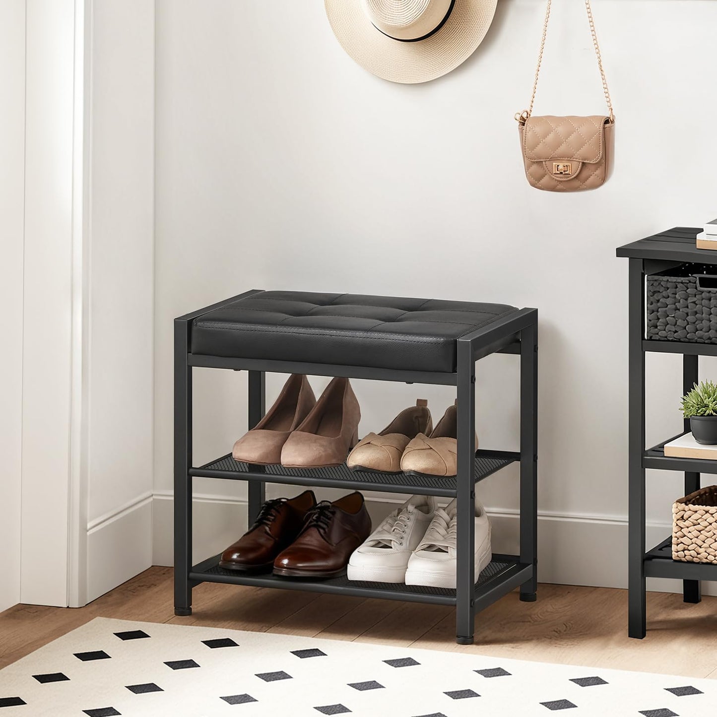 Black shoe rack with shoes on a wooden floor in a room.