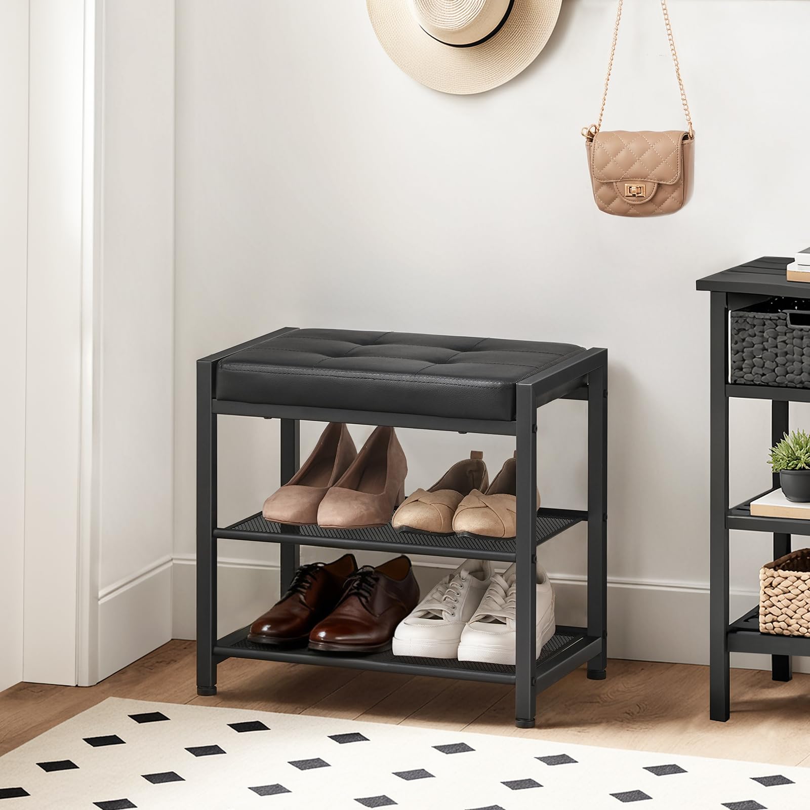 Black shoe rack with shoes on a wooden floor in a room.