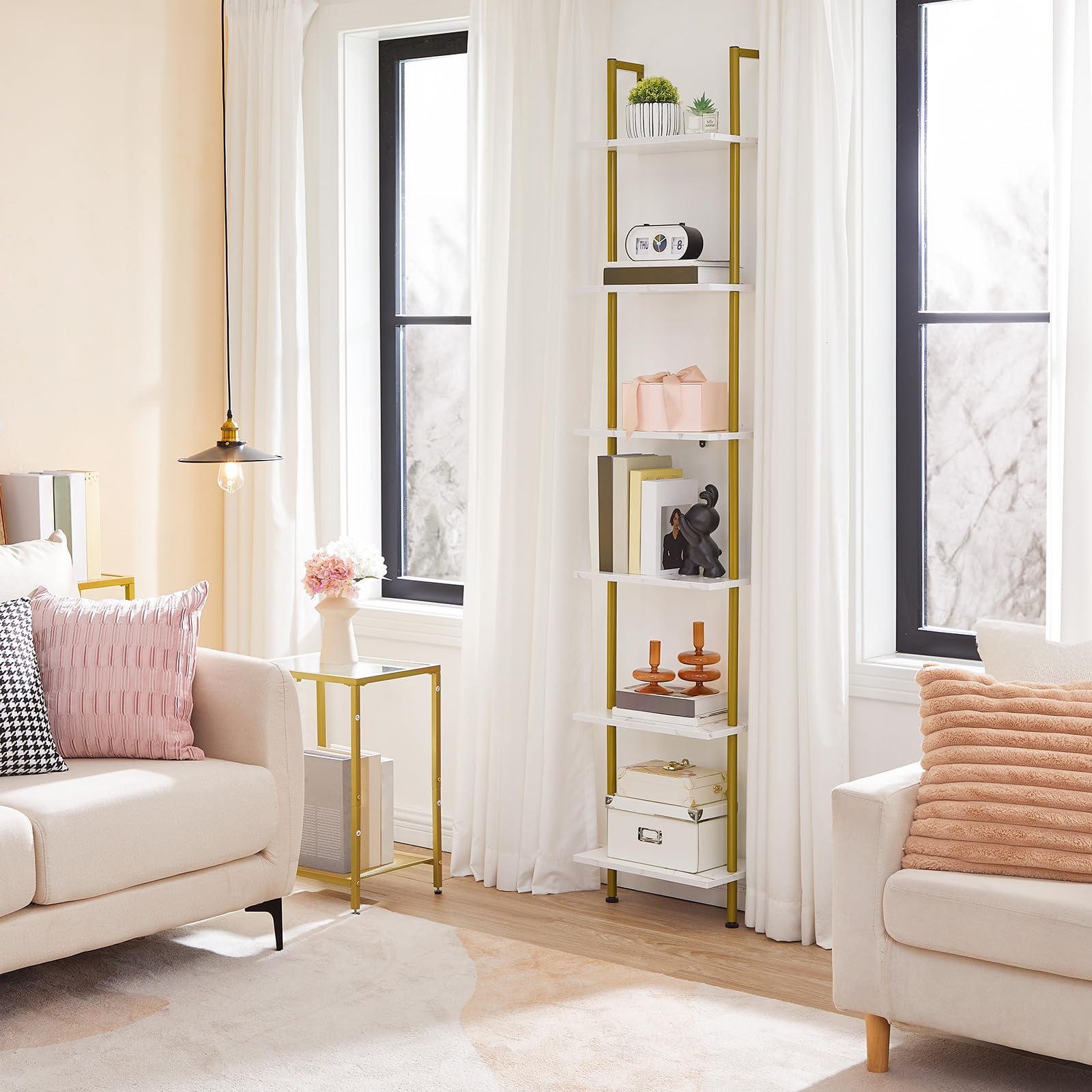 Living room with a gold bookshelf, white sofa, and decorative pillows.