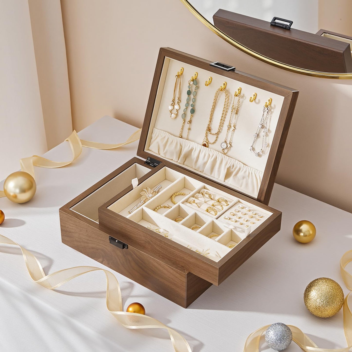 Wooden jewelry box with jewelry on a white surface with decorative ribbons and ornaments.