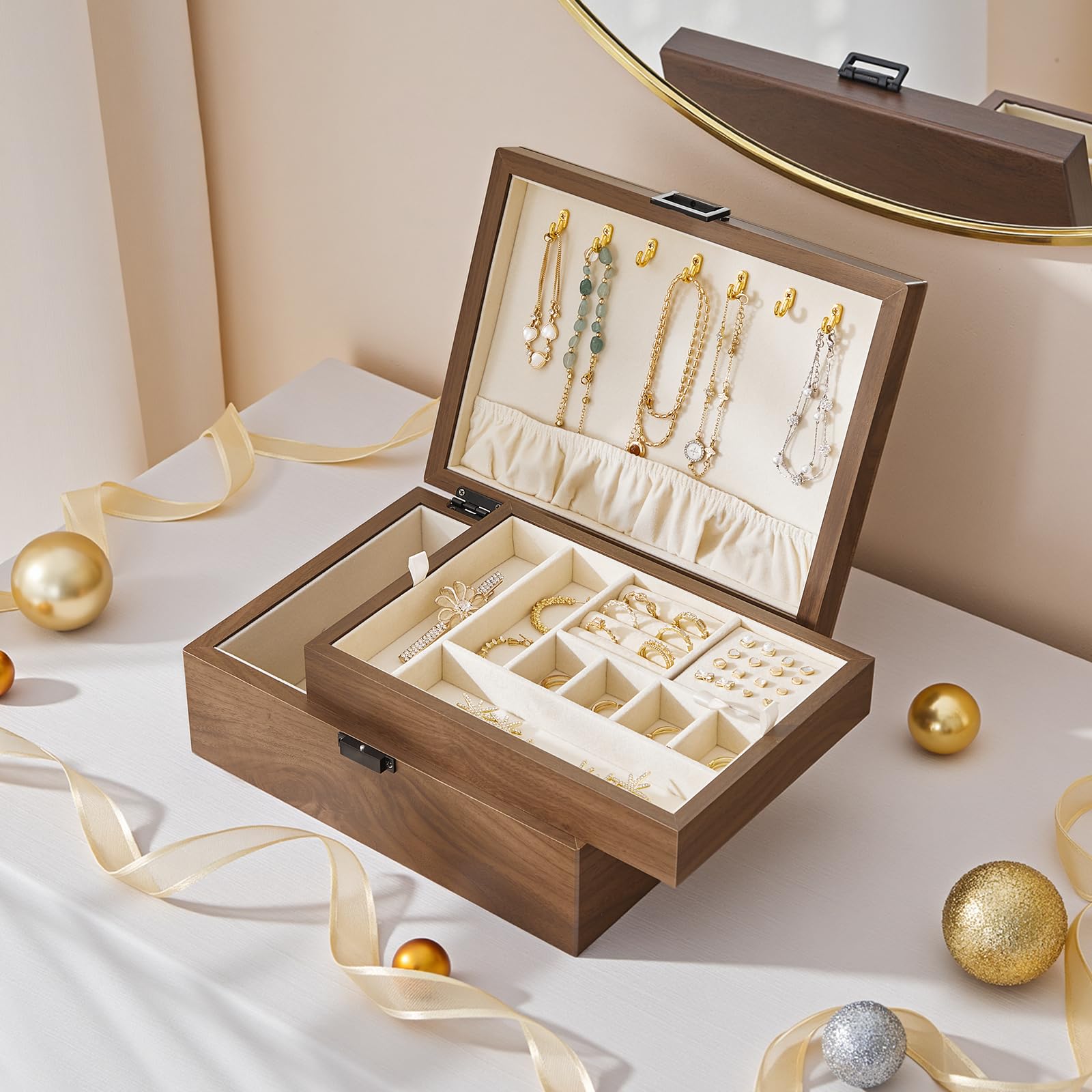 Wooden jewelry box with jewelry on a white surface with decorative ribbons and ornaments.