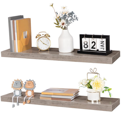 Two wooden shelves with decorative items including books, a clock, and small plants on a white background.