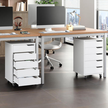 Modern office desk with computer setup and white drawers in a bright room.