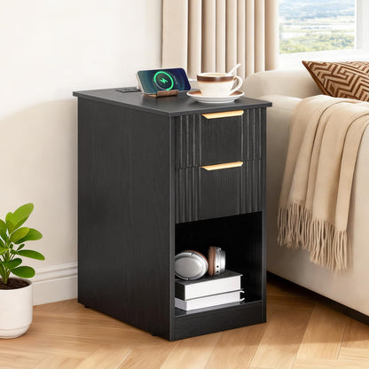 Black nightstand with a smartphone, cup, and books in a bedroom setting.