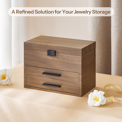 Wooden jewelry box with two drawers on a beige surface with flowers.