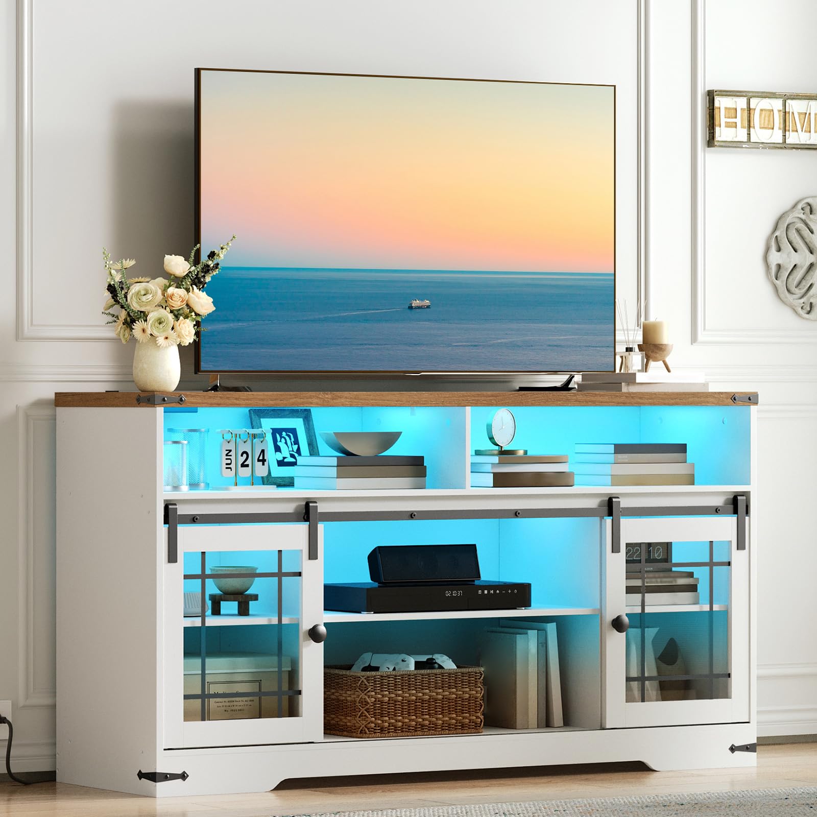 Modern entertainment console with a television displaying an ocean scene, surrounded by decorative items.