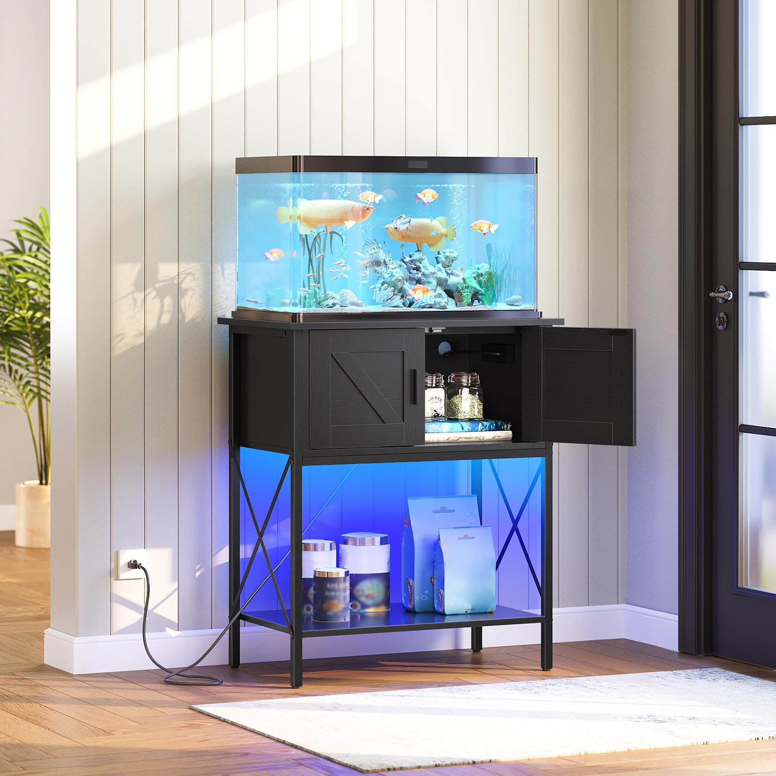 Fish tank with black stand and accessories on a wooden floor.