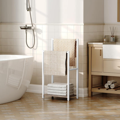 Bathroom with a freestanding bathtub, towel rack, and wooden cabinet.