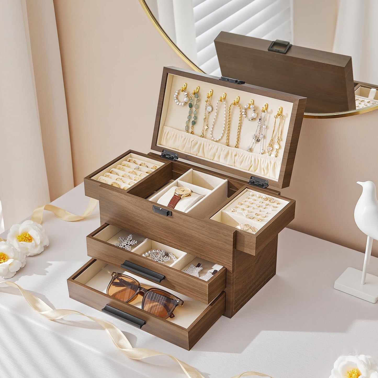 Wooden jewelry box with jewelry inside on a light surface.