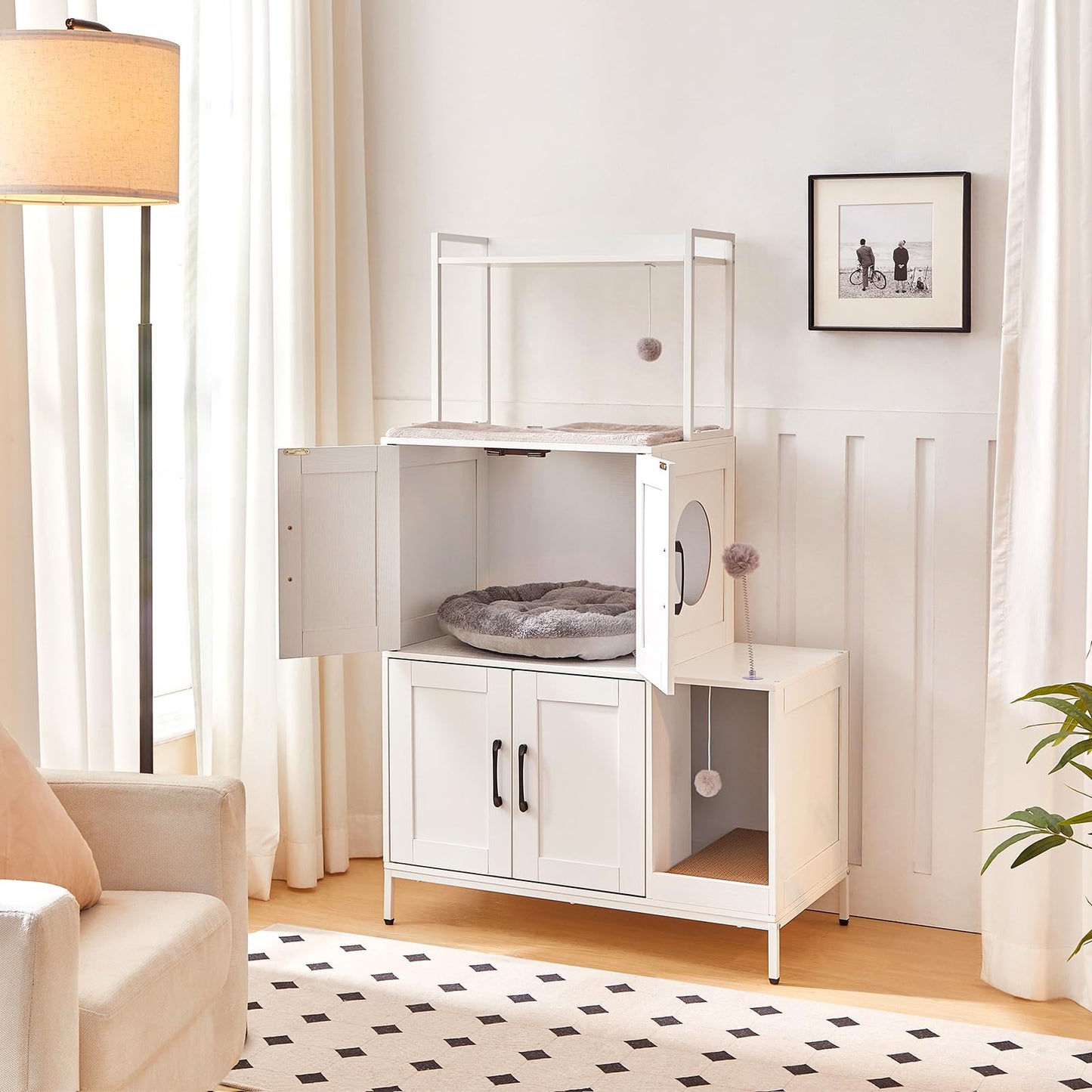White pet cage with open door in a room with a lamp, sofa, and plant.
