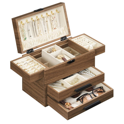 Wooden jewelry box with multiple compartments containing jewelry items on a white background