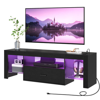 Black TV stand with purple LED lighting displaying a scenic image on a screen.