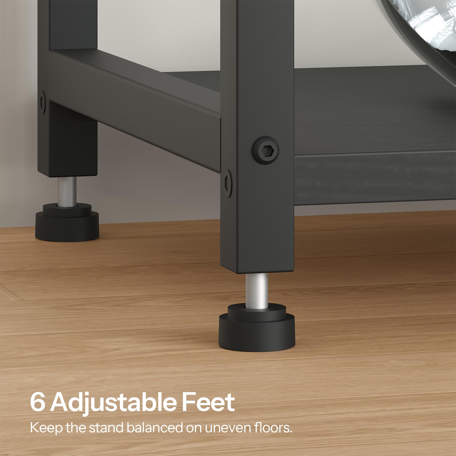 Close-up of a metal stand with adjustable feet on a wooden floor.