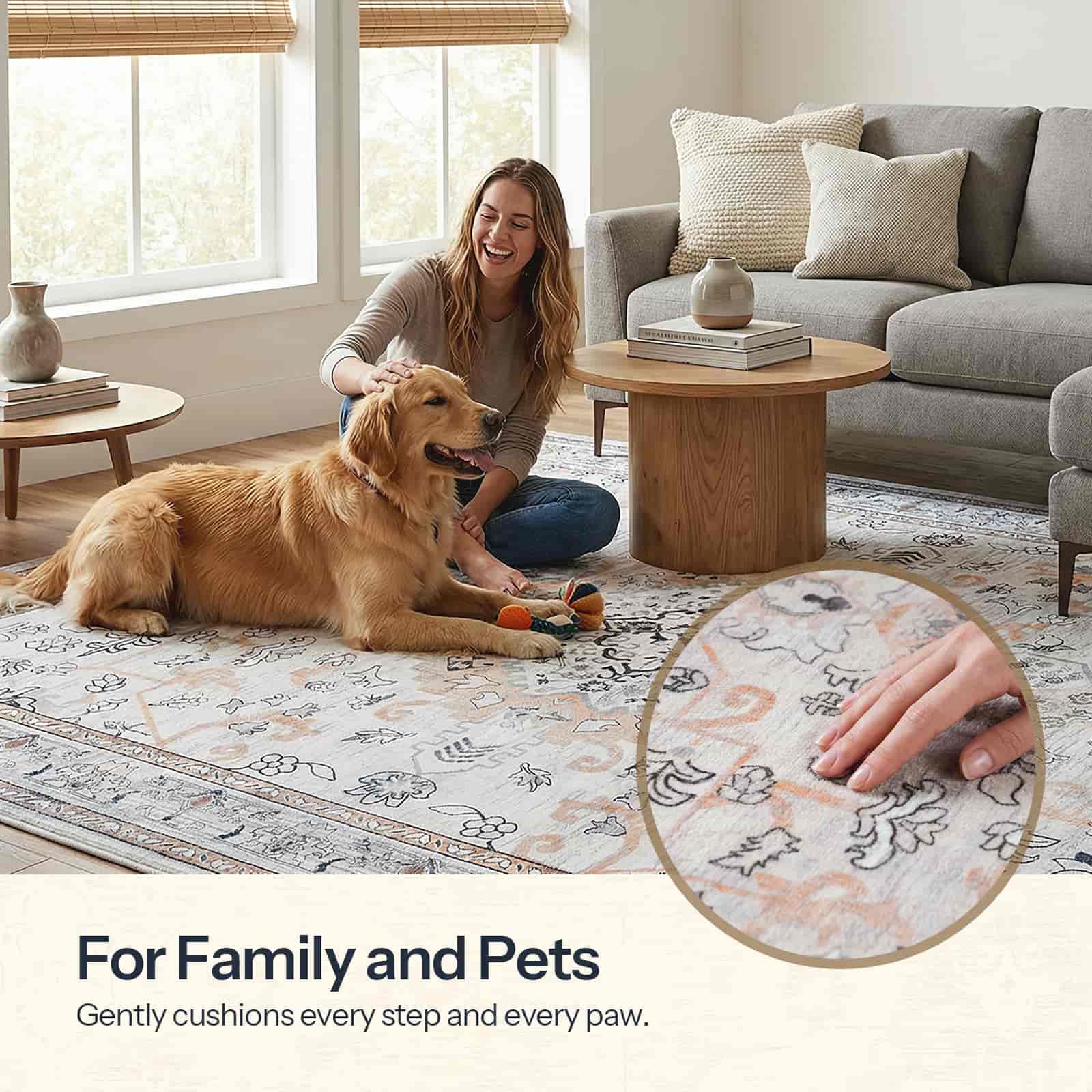 Woman playing with a dog on a patterned rug in a living room.