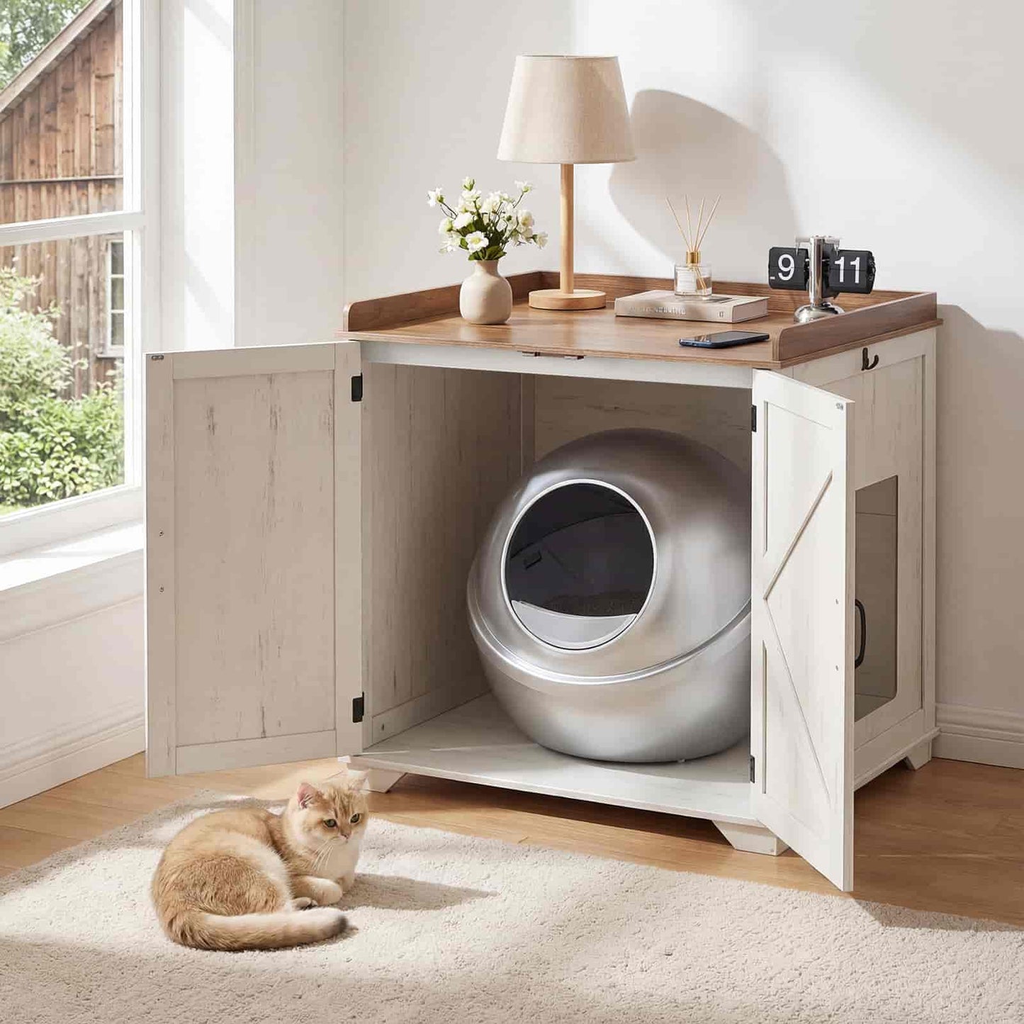 Cat litter box inside a wooden cabinet with a cat sitting on the floor.